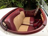 a white car with red leather seats in the back of it