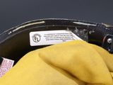 a close up of a yellow glove with a tag on it