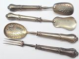 five spoons and a fork on a white surface