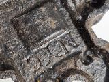 a close up of a metal object on a white surface