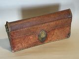a brown leather case with a metal clasp on it