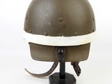 an old helmet on a stand on a white background