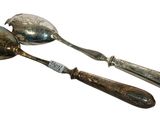 two spoons and a spoon on a white surface