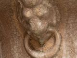 a close up of a vase with a lion head on it
