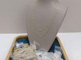 a display of gold and silver jewelry on a tray