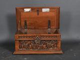 an old wooden box with carvings of horses and people on it