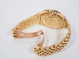 an image of a gold wrist watch with a chain around it