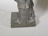 a statue of a man holding a bird on a stand