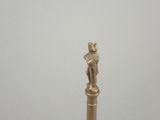 a gold statue of a cat on top of a pole
