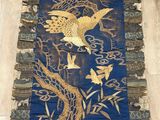 an image of a blue and gold rug with birds on it