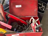 a red tool box with tools in it in a garage
