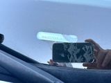 a person taking a picture of themselves in the mirror of a car