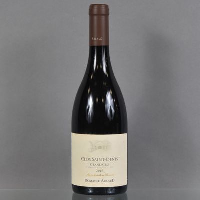 a bottle of wine sitting on a glass table