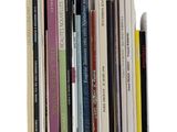 a lot of books that are stacked together on a shelf