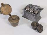 a small metal box with a lid and some metal objects