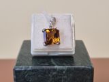sterling silver and citrine pendant on a marble block
