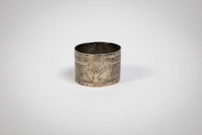 a close up of a silver ring on a white surface