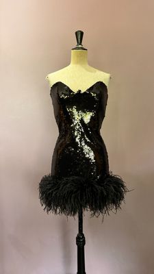 a mannequin with black feathers on a stand