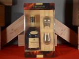a bottle of liquor and a glass in a box