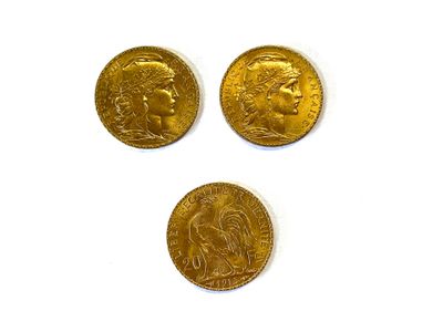 Trois pièces d'or sont représentées sur une surface blanche