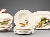 three plates and a bowl with fish on them