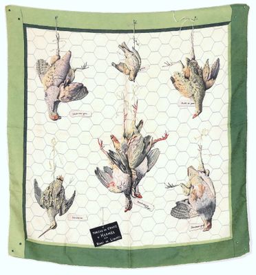 a green and white scarf with a picture of birds on it