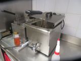 two deep fryers sitting on a counter in a kitchen