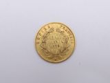 a close up of a gold coin on a white surface