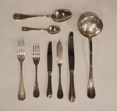 a lot of silverware on a table with spoons and forks