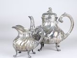 silver plated coffee pot and creamer on stand on white background