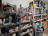 a room with a lot of clutter and tools on the shelves