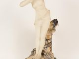 an image of a statue of a woman on a rock