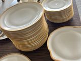 many plates and bowls on the table ready to be served