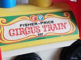 a toy train with a sign that says fisher price circus train