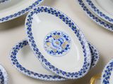 many blue and white plates and bowls on the table