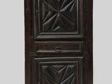 an old wooden cabinet with two doors and a clock on top of it
