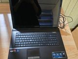 a laptop computer that is sitting on a wooden table
