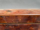 a brown wooden box with a handle on top of it