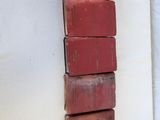 several red books stacked on top of each other on a wall