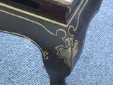 a black table with a gold decoration on top of it