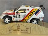 a model of a rally car on display in a glass case