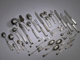 a lot of silver spoons and spoon spoons on the table
