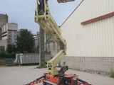 a crane that is sitting on the ground in front of a building