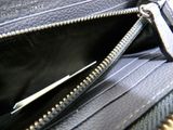 a black purse with a zipper open on a table
