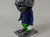 a small figurine of a person with a hat on
