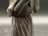 a statue of a woman holding a bird in her hands