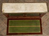 an overhead view of a green area rug and a wooden bench