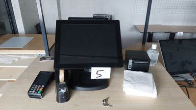 a computer monitor sitting on top of a wooden desk