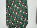 a green neck tie with birds and flowers on it