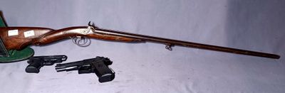 rifle and gun on a white table with a white background